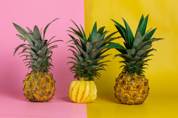  exotic tropical fruits, pineapple isolated on a yellow and pink background