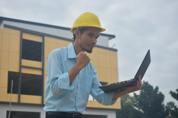 Engineering use computer notebook presentation at work place building estate construction background