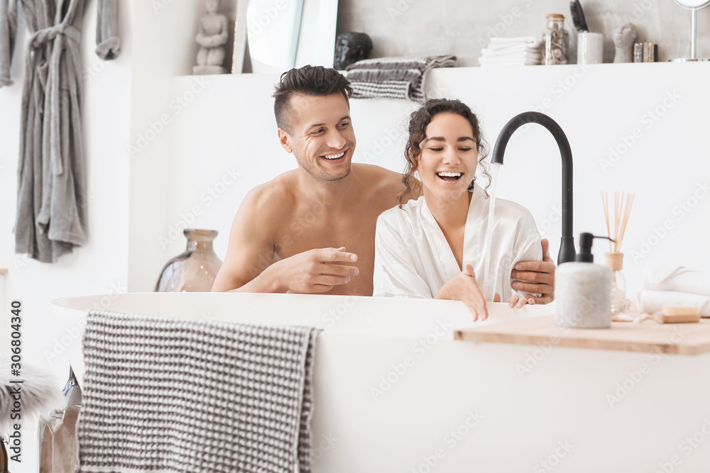 Happy young couple in bathroom at home