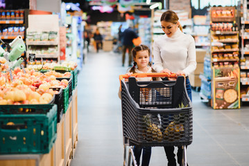 Mother with daughter at a grocery store