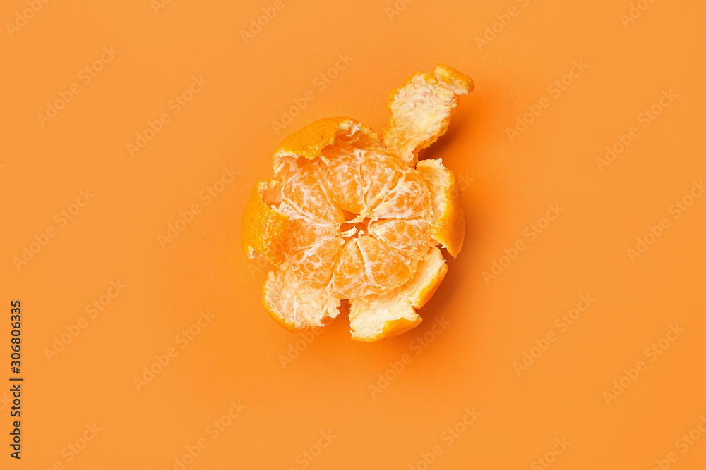 Ripe peeled tangerine on color background