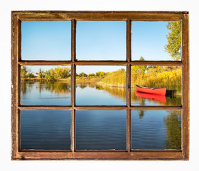 Wall Mural - red canoe on a lake shore