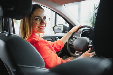 Business woman driving her new car