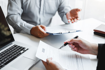 Wall Mural - Senior manager HR reading a resume during a job interview employee young man meeting Applicant and recruitment