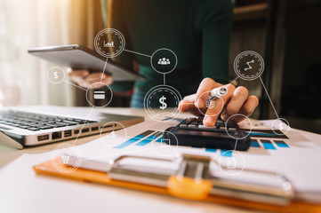 Businessman hand using laptop, tablet and smartphone  in office. Digital marketing media mobile app in virtual icon screen