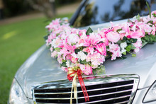 Wedding Car. Wedding Decoration On Wedding Car. Luxury Wedding Car Decorated With Flowers. Just Married Sign And Cans Attached.