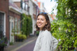 © papa - Portrait of a Happy young woman on the background of a city street in the summer.
