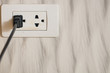 Focus white plug socket 2 channels on the wood wall. electricity for house and city. charging energy concept. image for background, copy space.