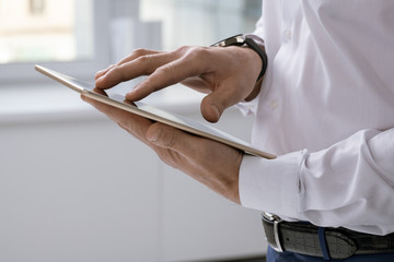 Aufkleber - Hands of elegant businessman with tablet scrolling through online data