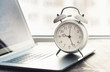 © kucherav - Work time concept. Home office with laptop, graph and alarm clock