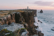 Lighthouse On The Edge Of A Cliff Big Ocean Waves Crash On A Rock Peniche Portugal