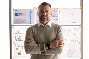 Aufkleber - Casual mature businessman standing against whiteboard with documents