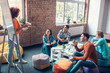 © zinkevych - Friends sitting at the table and listening to their team leader