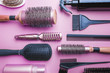 © petrrgoskov - Various hair dresser and cut tools on pink background with copy space