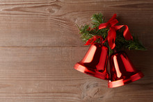 Red Jingle Bells On Wooden Background