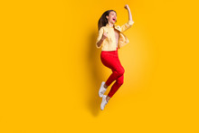 Full Length Body Size Photo Of Cheerful Excited Crazy Woman Rejoicing In Having Become Able To Jump In Red Pants Screaming Isolated Vivid Color Background