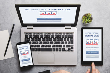 dental care concept on laptop, tablet and smartphone screen
