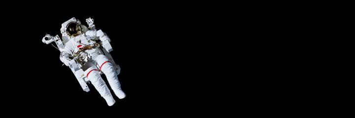 astronaut with a jetpack isolated on black panoramic background with copy space - elements of this i