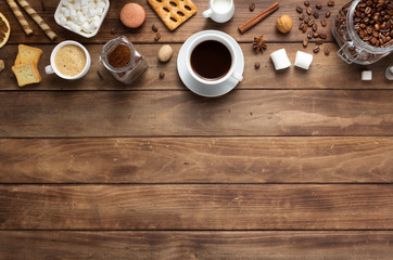 Poster - coffee beans with cup at wooden table background