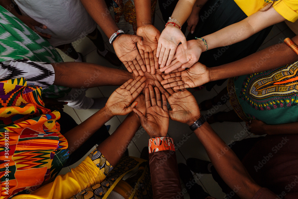 Palms up hands of happy group of multinational African, latin american and european people which stay together in circle - obrazy, fototapety, plakaty 