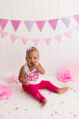 little girl black on white background. baby's first birthday. the inscription on the shirt in Ukrainian 