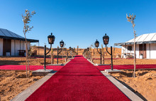 Red Carpet Main Path Between The Tents Of Luxury Golden Camp Site In Sahara Desert Merzouga, Morocco On A Sunny Day
