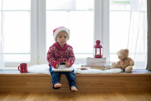 Sweet Blonde Child, Boy, Sitting On Window Shield With Teddy Bear Friend Toy, Writing Letter To Santa Claus And Reading Book