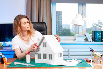 Poster - the girl works as an architect. new apartment. gluing the layout of the future building. the develop