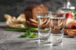 Cold Russian vodka with snacks on grey table, closeup