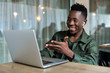 © producer - Handsome african american man using computer and smiling. Online video chat with friends