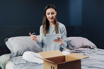 Person making online order sitting at home. Easy to understand app for mobile devices. Shipment of high quality goods worldwide. Quick delivery, goods at discount on promo codes. Easy money refunding