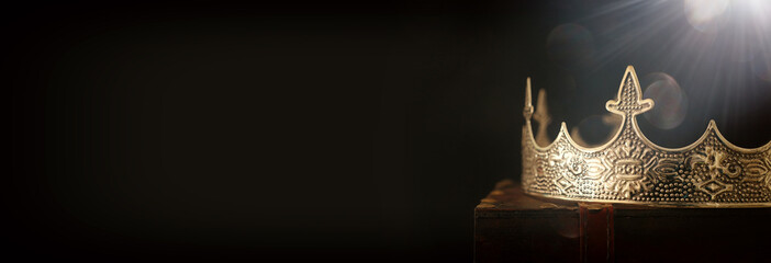 low key image of beautiful queen/king crown over wooden table. vintage filtered. fantasy medieval pe
