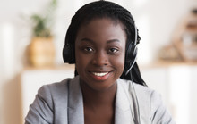 Portrait Of Black Smiling Female Call Center Operator In Headset