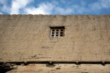 Small Traditional Window With A Wooden Mesh On A Beige Wall In A Residential Building Of The City Of Samar In Nepal, Mustang District.