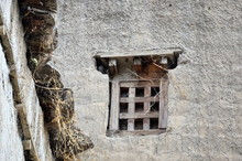 A Small Traditional Window With A Wooden Mesh On A Whitewashed Wall In A Residential Building In The City Of Samar In Nepal, Mustang District.