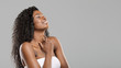 © Prostock-studio - Delighted beautiful afro girl enjoying touching her soft skin