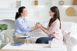 © Prostock-studio - Psychotherapist and female patient uniting hands together due successful therapy
