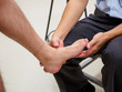 Closeup detail of a physician examining a patient's foot. Healthcare and podiatry.