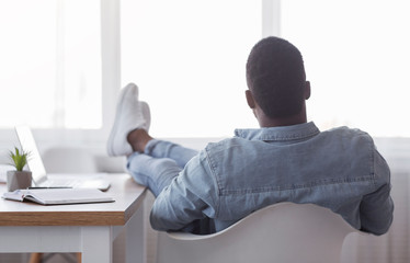 Poster - Lazy employee sitting with legs on desk and looking to window