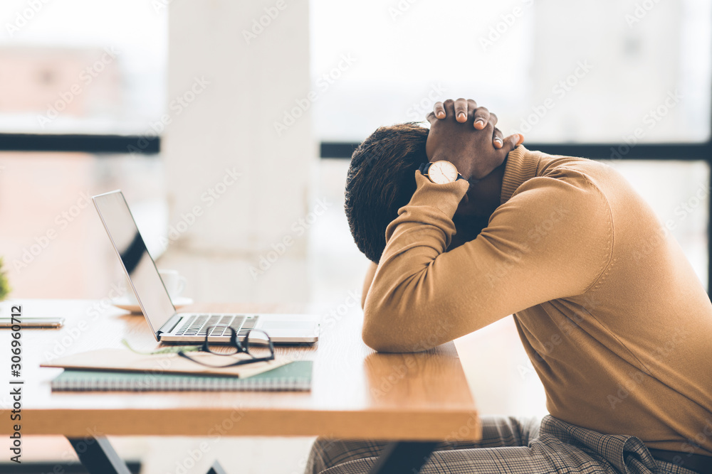 Exhausted african american manager feeling sad and desperate - obrazy, fototapety, plakaty 