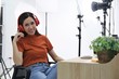 Young model wearing headset in  photographer studio background