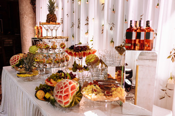 Fresh, exotic, organic fruits, light snacks in a plate on a buffet table. Assorted mini delicacies and snacks, restaurant food at event. Decorated delicious table for a party goodies.