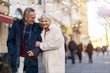 © pikselstock - Senior couple walking on the city street at winter day