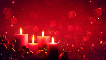 Wall Mural - four red candles with christmas ornament in shiny glitter