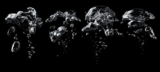 Wall Mural - Air bubbles in the water on black background.