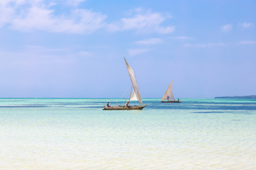 Two Traditional Dhow Boats Sailing