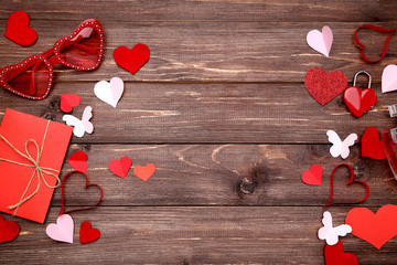 Wall Mural - Paper hearts with sunglasses and envelope on brown wooden table