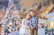 © Евгения Янцева - fair-haired happy cute children brother and sister 6-7-8 years near the Christmas tree, on the eve of the New Year's holiday hold snow in their hands, light colors, pink and blue