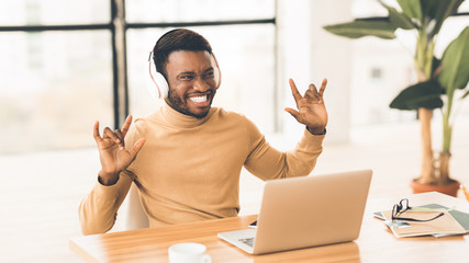 Young african businessman listening to rock with headset