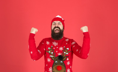 Wall Mural - I am winner. Buy festive clothing. Sweater with deer. Hipster cheerful bearded man wear winter sweater and hat. Happy new year. Join holiday party craze and host ugly christmas sweater party